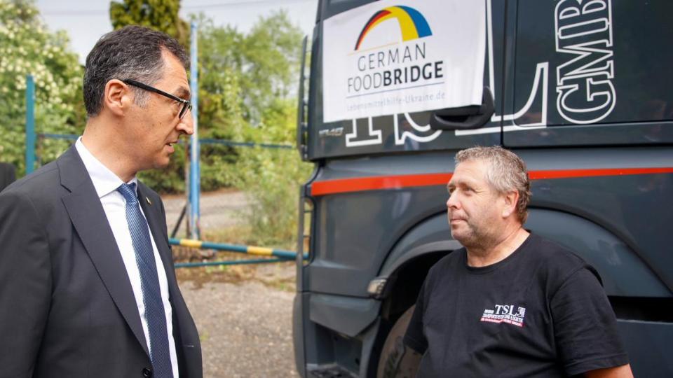 Bundesminister Özdemir im Gespräch mit einem LKW-Fahrer, der Lebensmittel zum Lebensmittel-Hub nach Dębica/Polen gebracht hat.